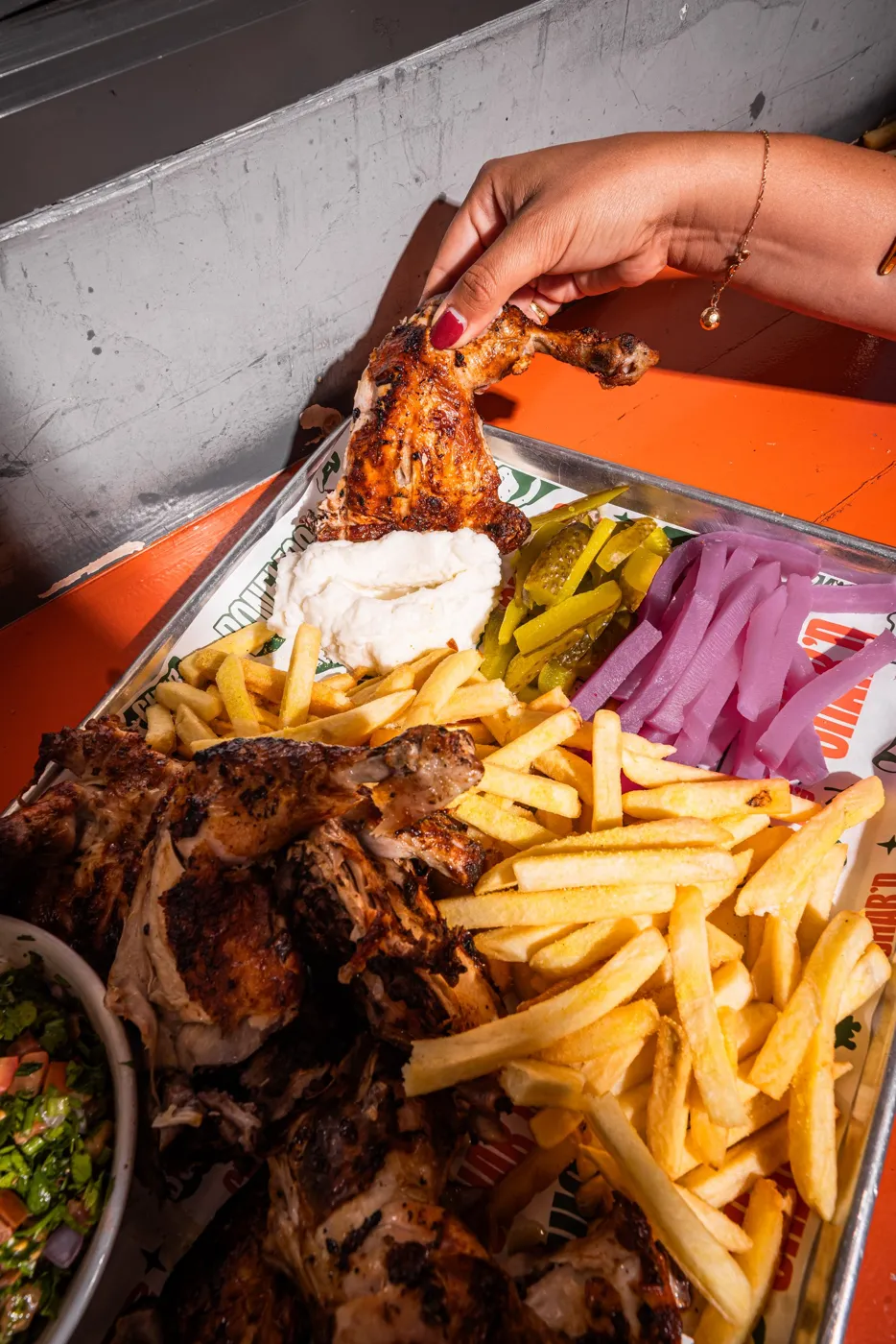 Charcoal chicken with chips, pickles, garlic sauce and salad on a Char’d tray
