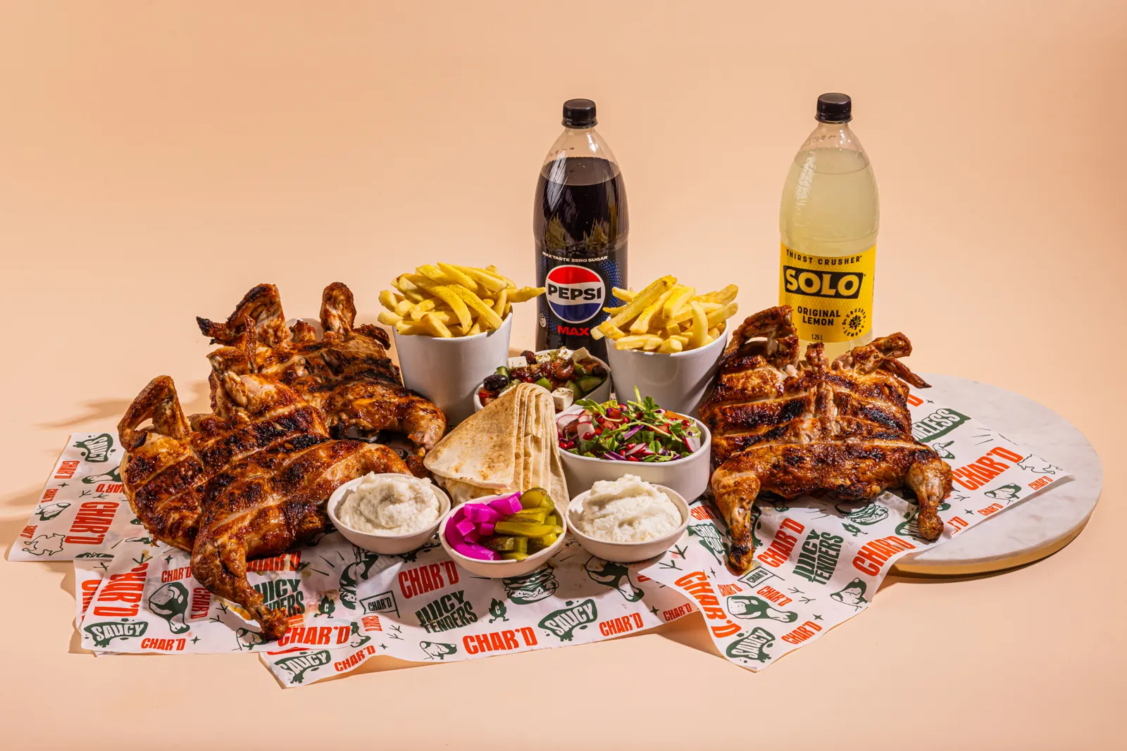 Two Char'd charcoal chickens with chips, salads, garlic sauce, bread and drinks